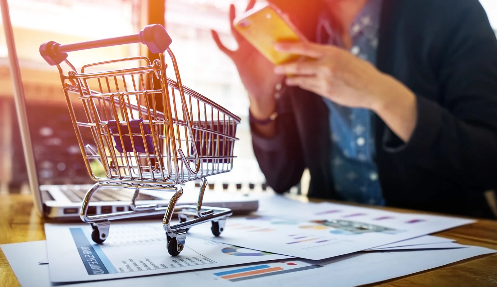 cropped-image-woman-inputting-card-information-key-phone-laptop-while-shopping-online